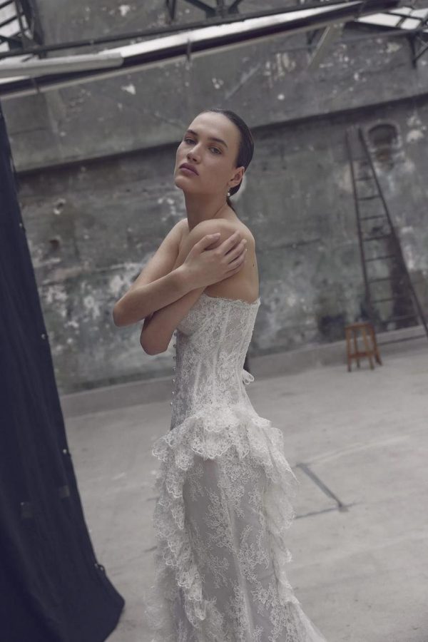 Cascadelle ivory lace mermaid wedding dress by Ricca Sposa with a sculptural peplum